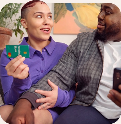 A woman is holding a Starling Bank card