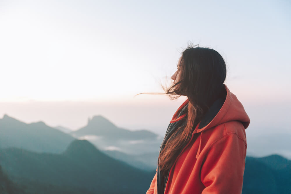 Person looks out over mountain top