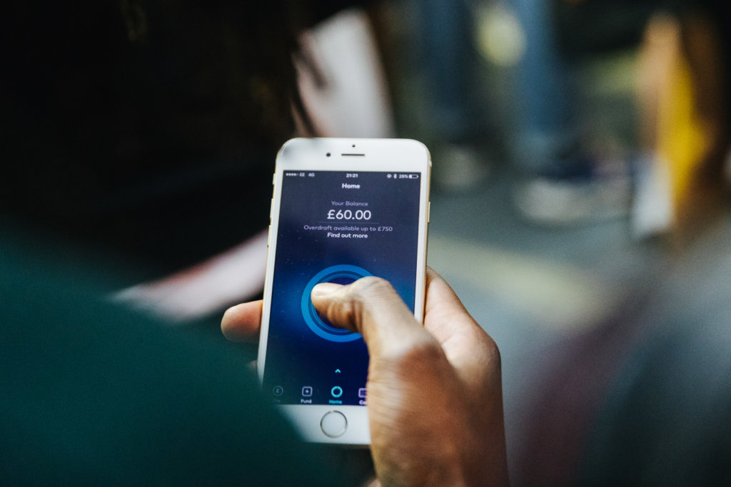 person holding phone with Starling bank app