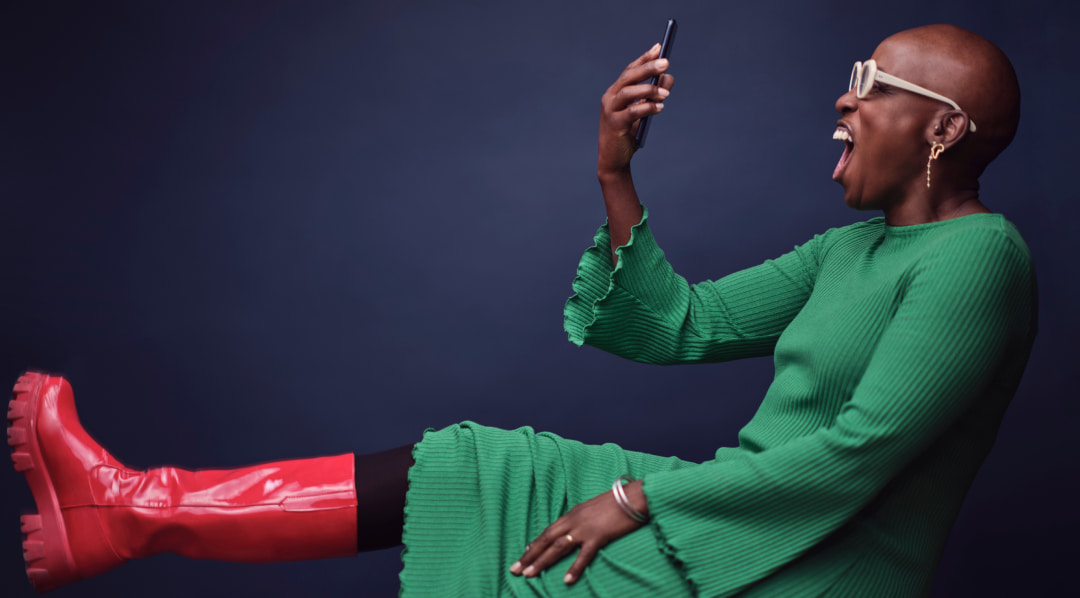 Woman in red boots looking at the phone