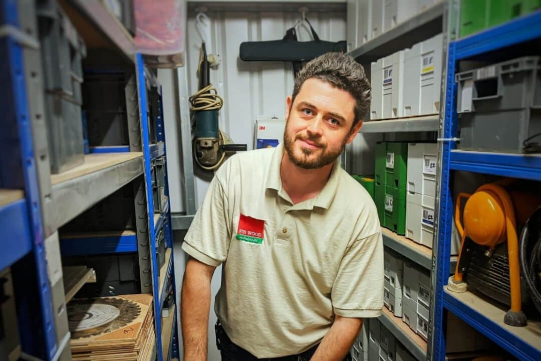 Founder of Fin Wood in a warehouse where he keeps tools and supplies