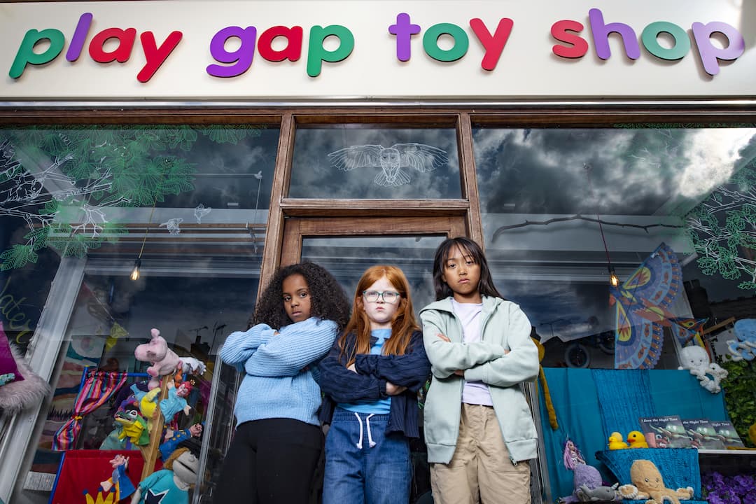 Girls stood in front of toy store