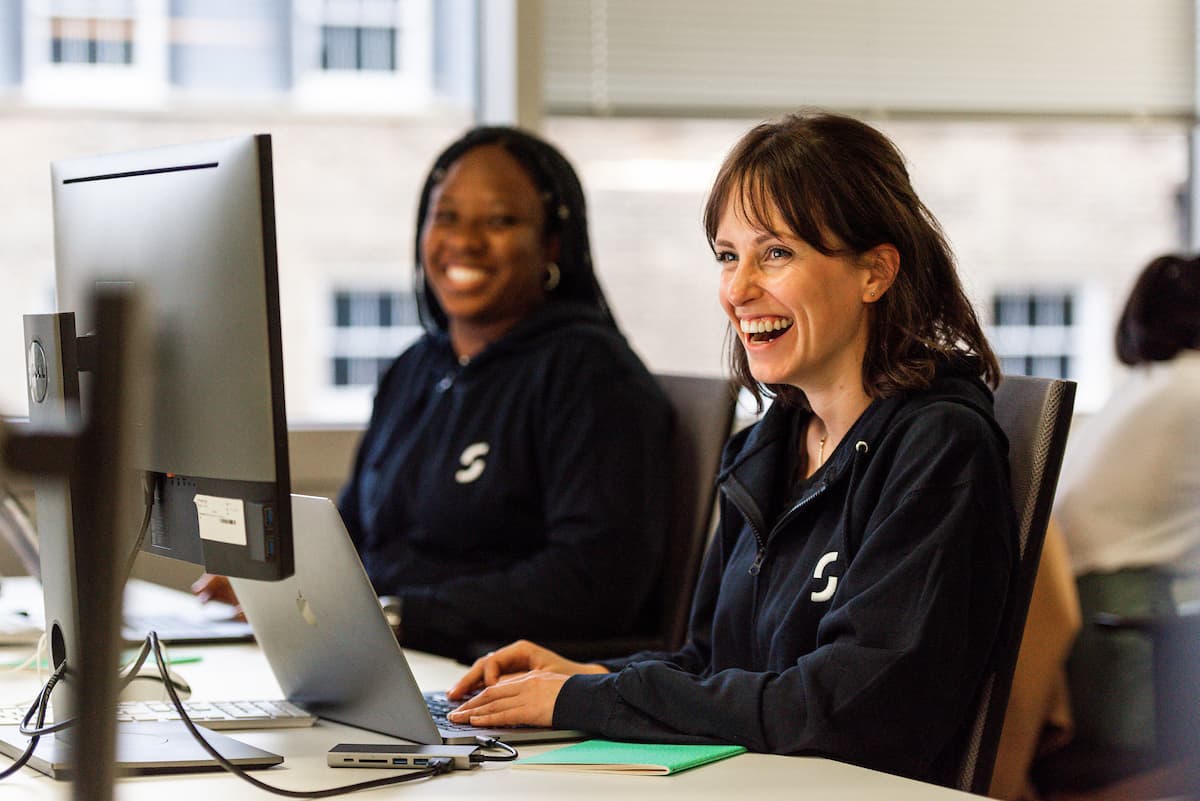 Two woman looking at the screens