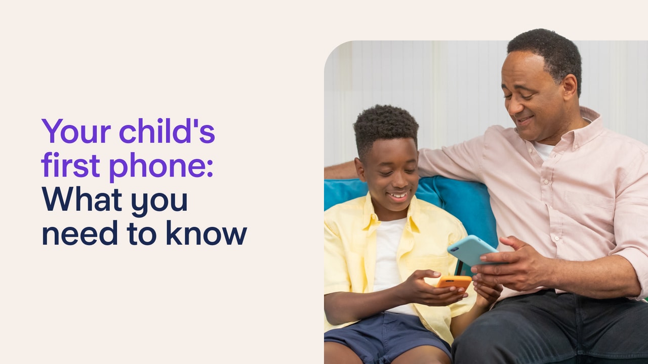 Image of a man and a boy sitting on a sofa with phones in their hands.