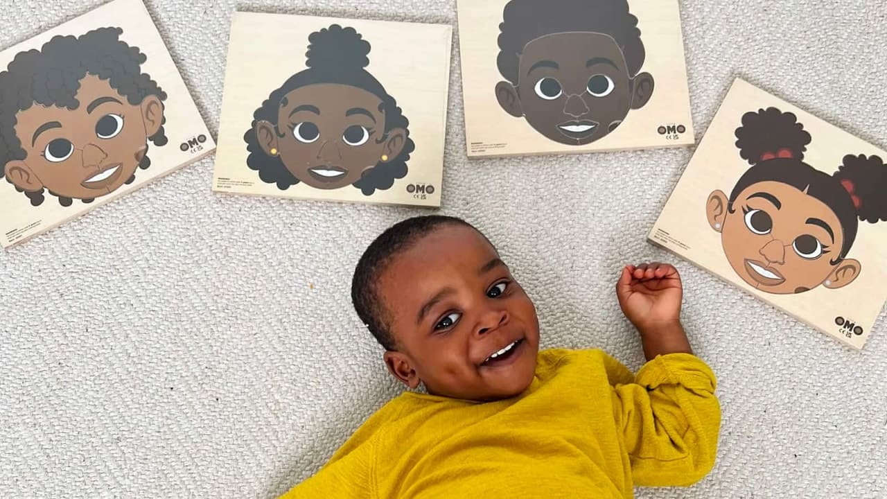 Baby laying down with cartoons above