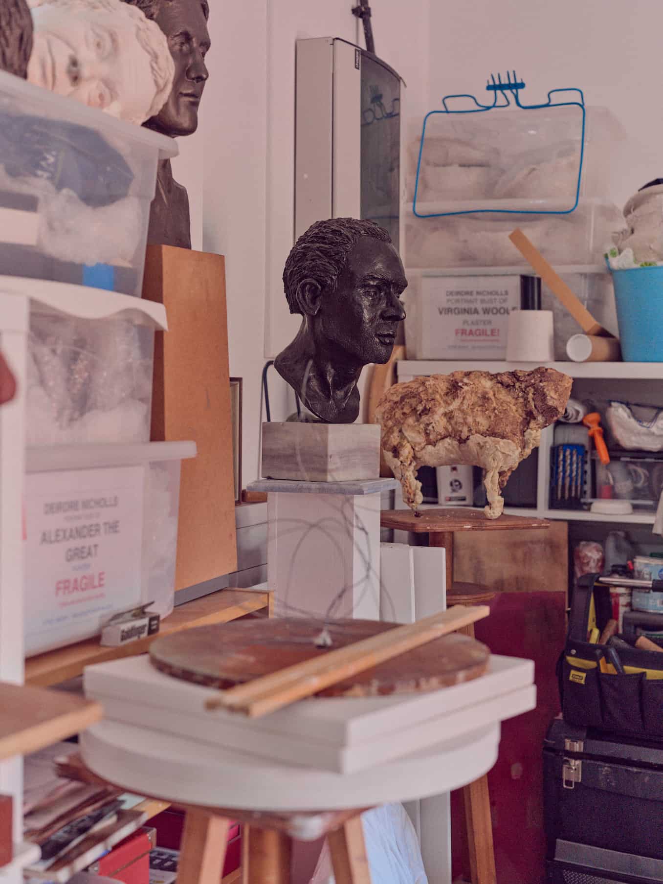 Bust of a man in bronze and other assorted items in Deirdre Nicholls' studio