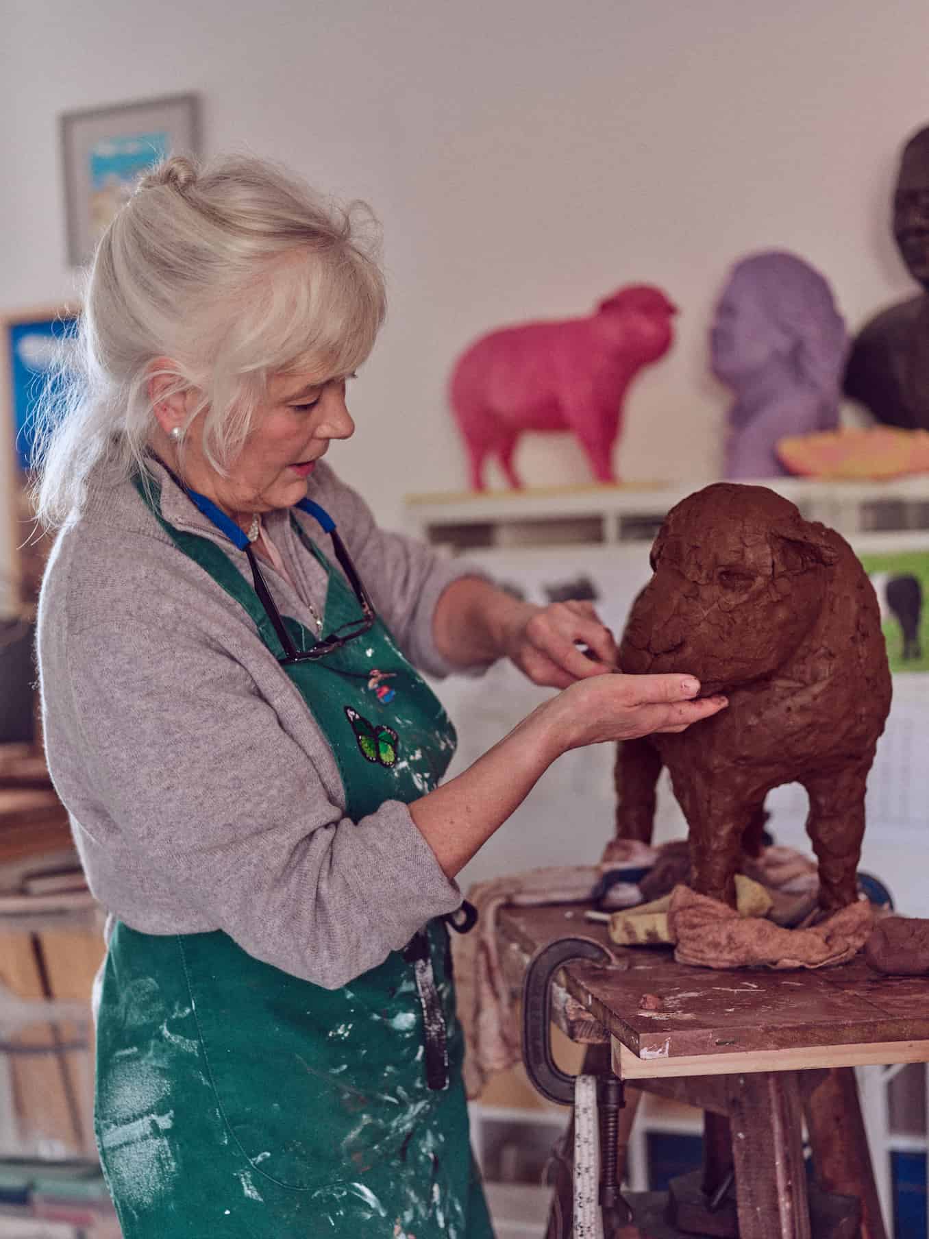 Sculptor Deirdre Nicholls working on the clay for her next sculpture, a belted Galloway calf