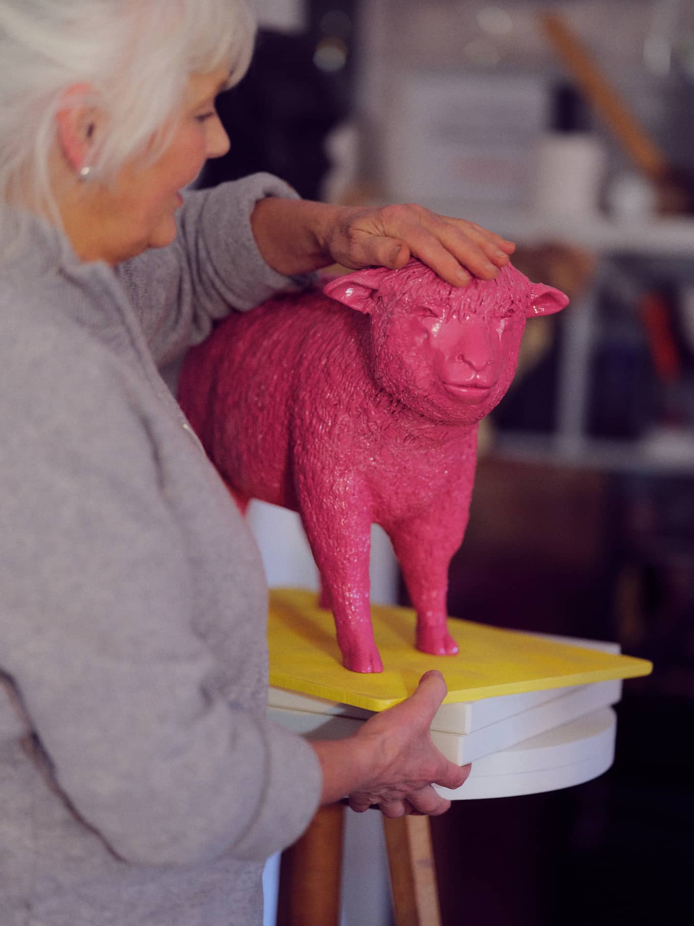 Deirdre Nicholls in her studio with her pink resin sheep sculpture, titled Hello Dolly