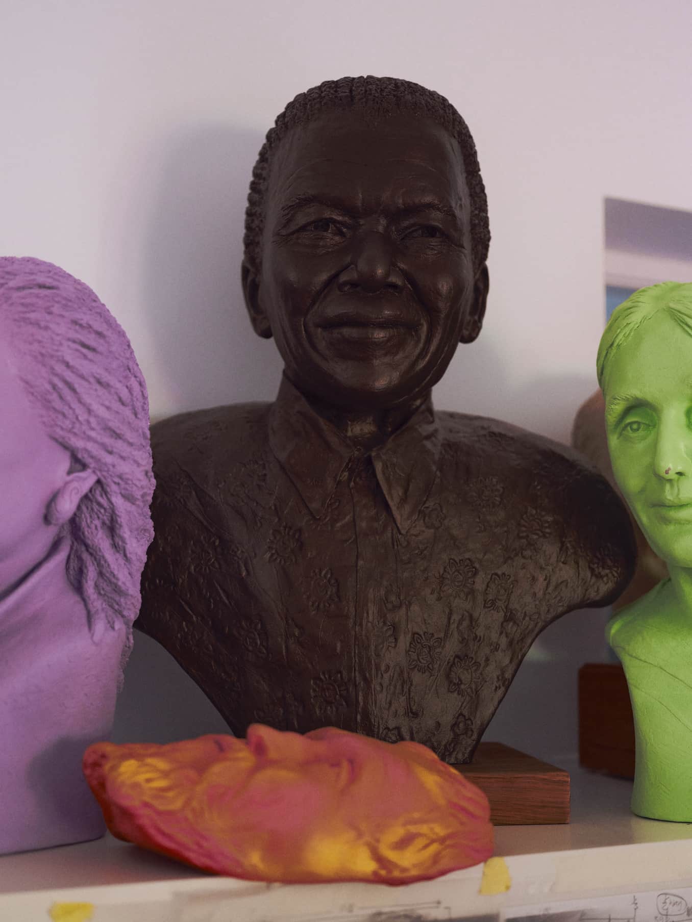 Photograph of the bust Deirdre Nicholls created of Nelson Mandela, with Toni Morrison bust on the left and Virginia Woolf bust on the right
