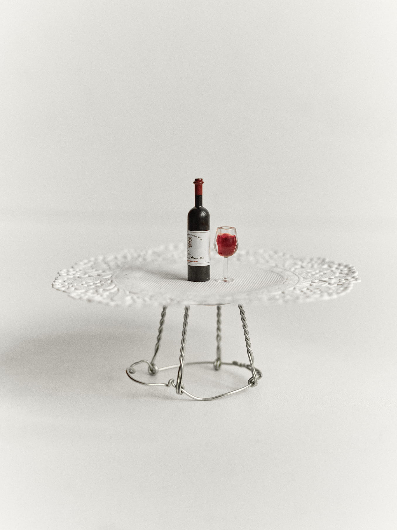 Miniature wine bottle and glass on a table