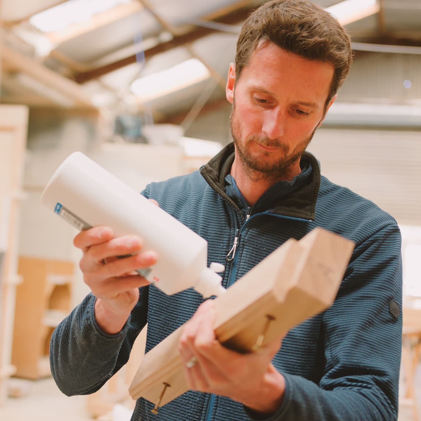 Man applying wood glue to furniture
