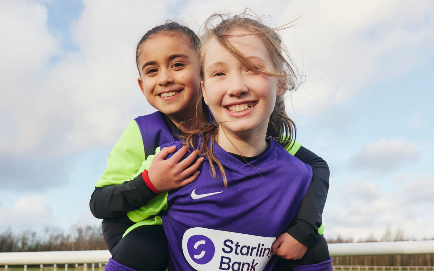 One Astley & Tyldesley football player gives a piggy back to another