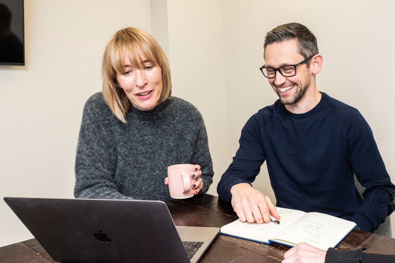 Dan Sheridan and freelance media public relations expert Anna Thomas looking at the laptop screen.