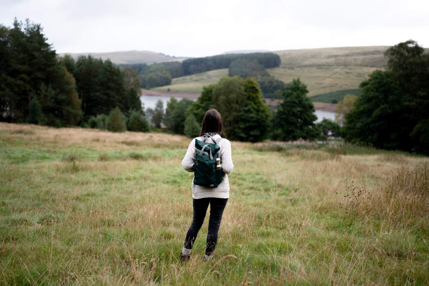 Charlotte facing hills with the backpack on a hike