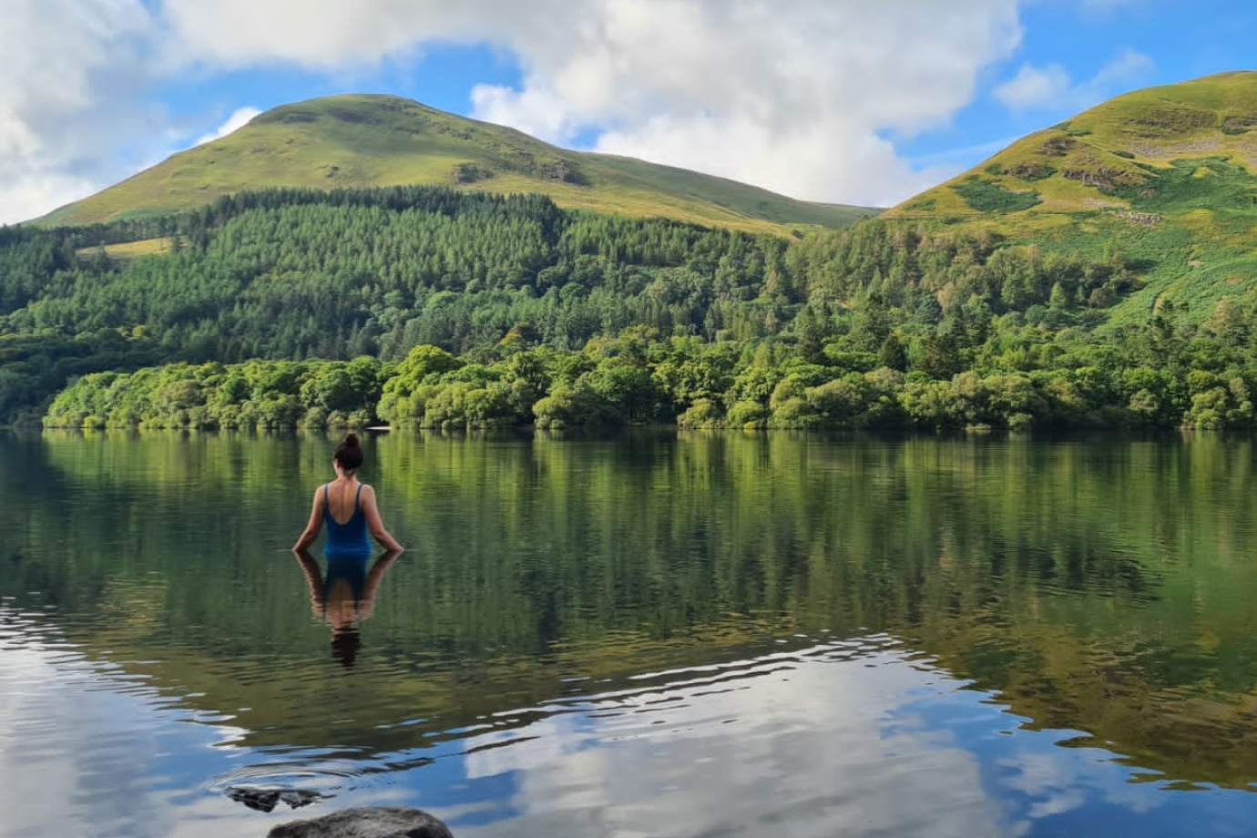 Charlotte swims in a lake
