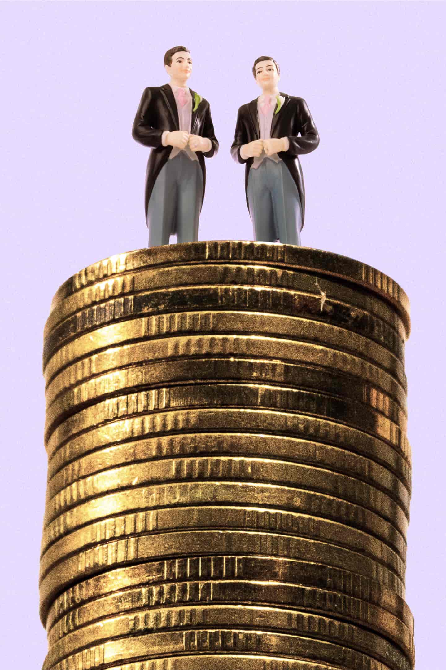 Small figures of two grooms, dressed in morning suits stand on a pile of gold coins. The figures are the sorts you would find on top of a wedding cake.