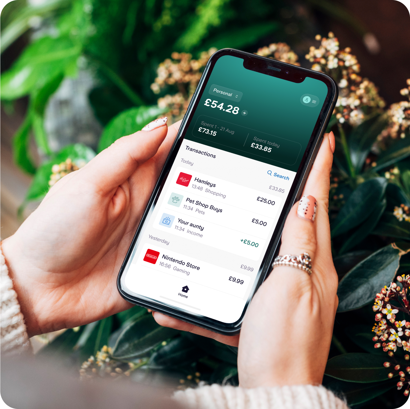 Hand holding phone showing latest transactions