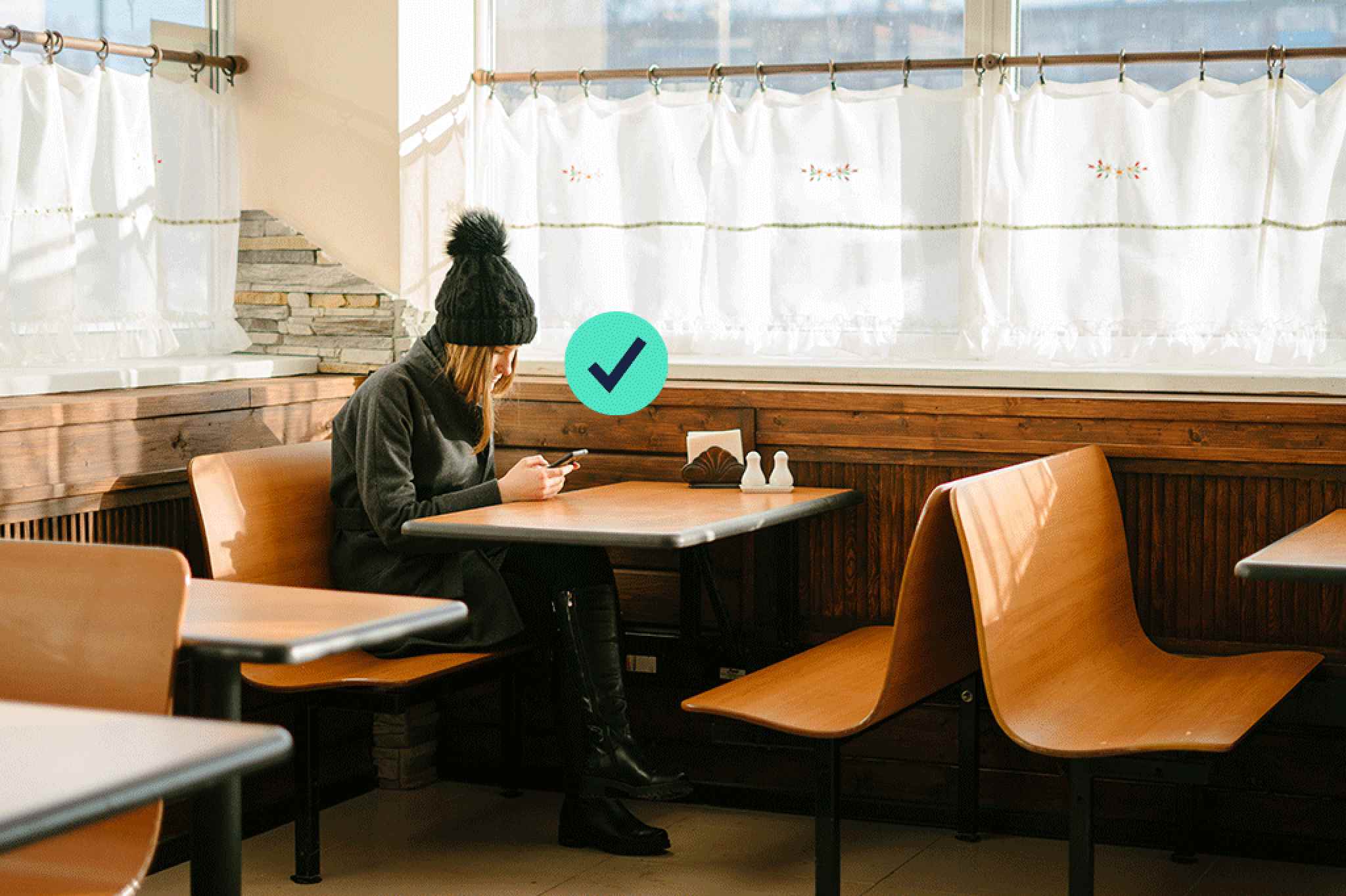 Woman sitting in the cafe looking at the phone