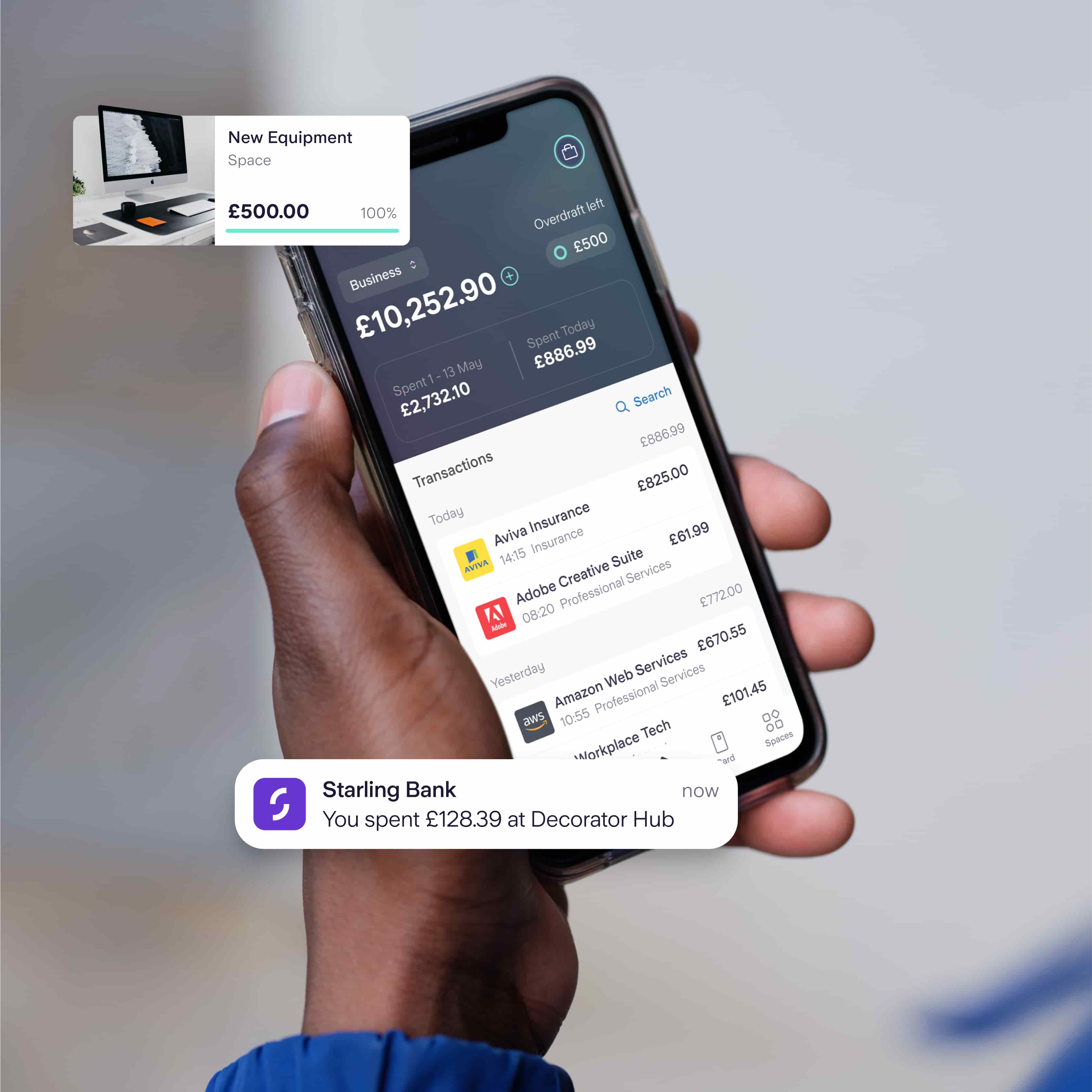 hand holding a phone with the Starling business banking app displaying payment feeds