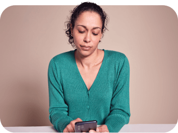 A woman looking at her phone using the Starling app