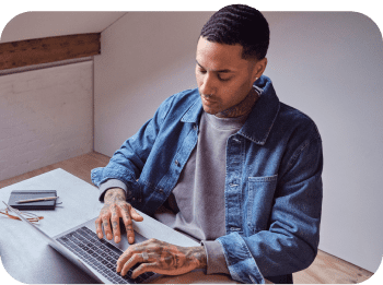A man sat at a laptop budgeting