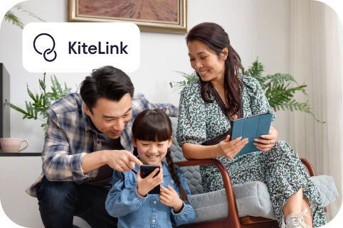A family, with a daughter showing a phone to her dad