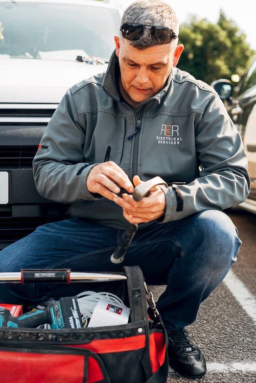 Tony kneeling down next to his toolbox