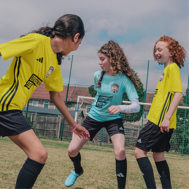 A girls team playing football