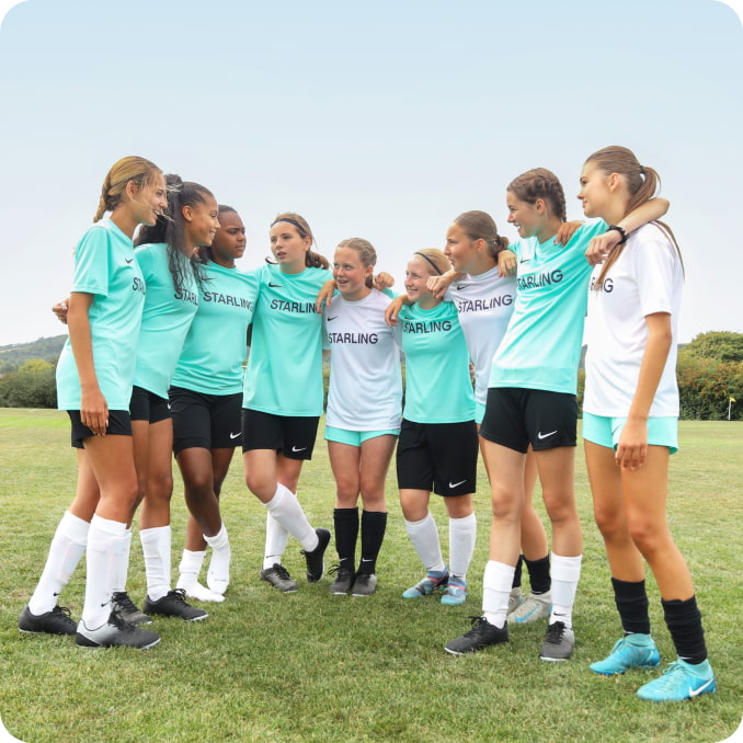 Girls football team with new Starling kit
