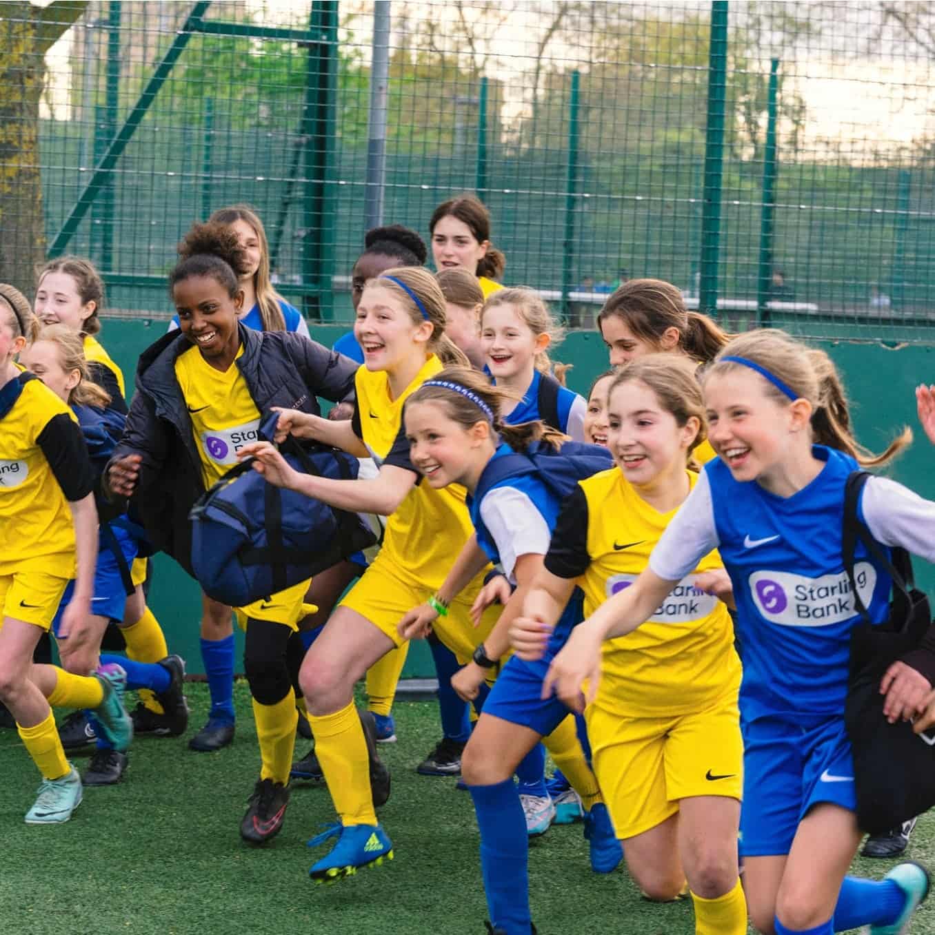 A girls football team with Kick On kit