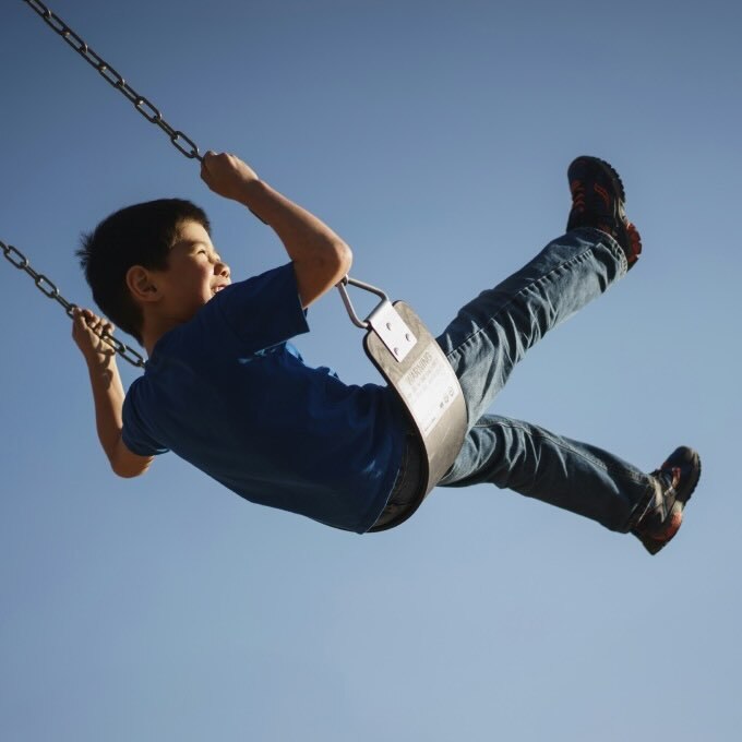 image shows boy on swing