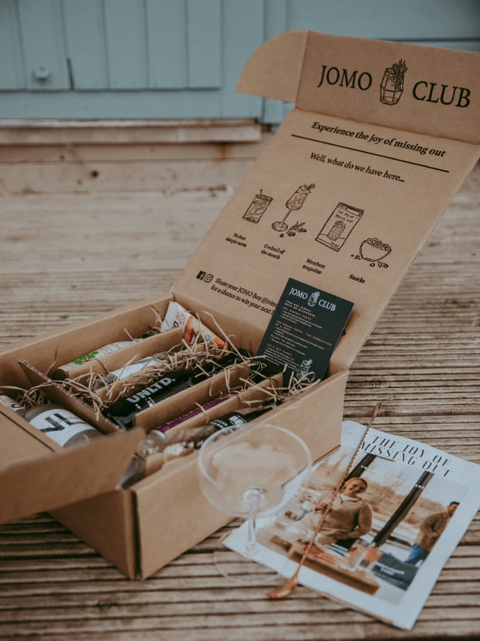 Box from JOMO Club containing some drinks