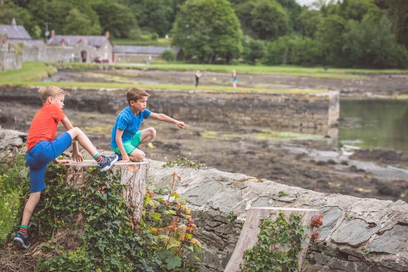 Two children exploring, pointing at something in the distance