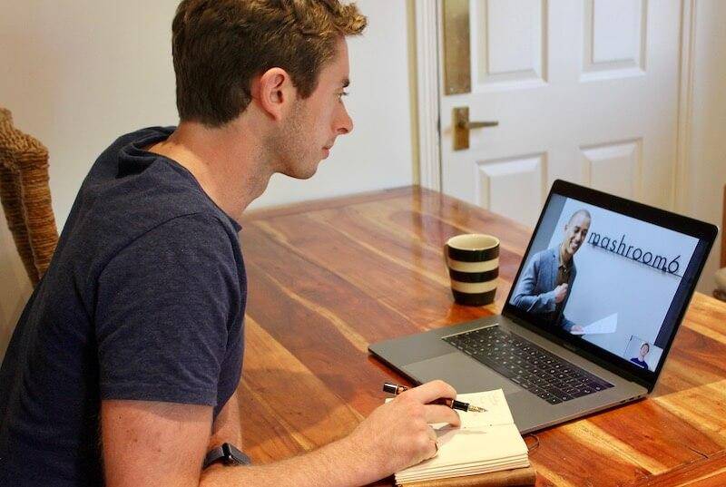 Alex sits at his computer working.