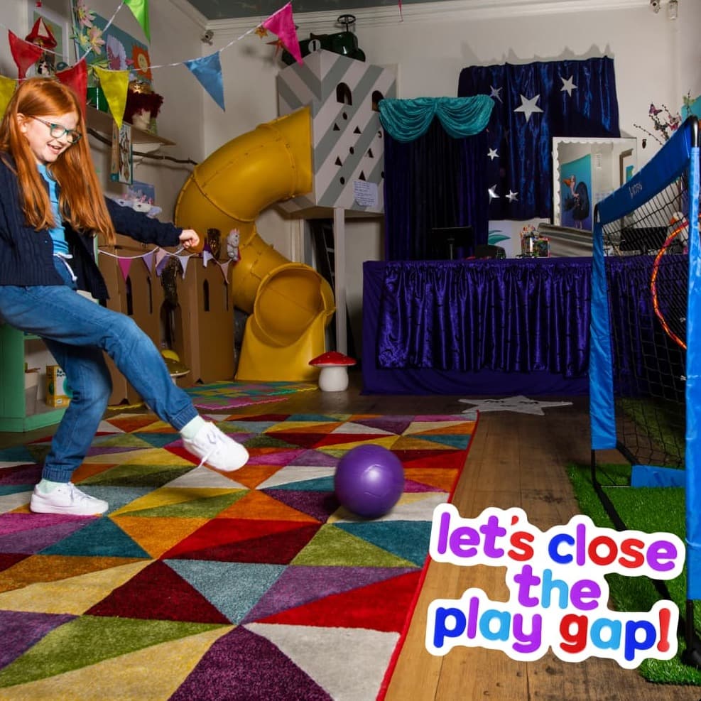 Girl playing football in playroom