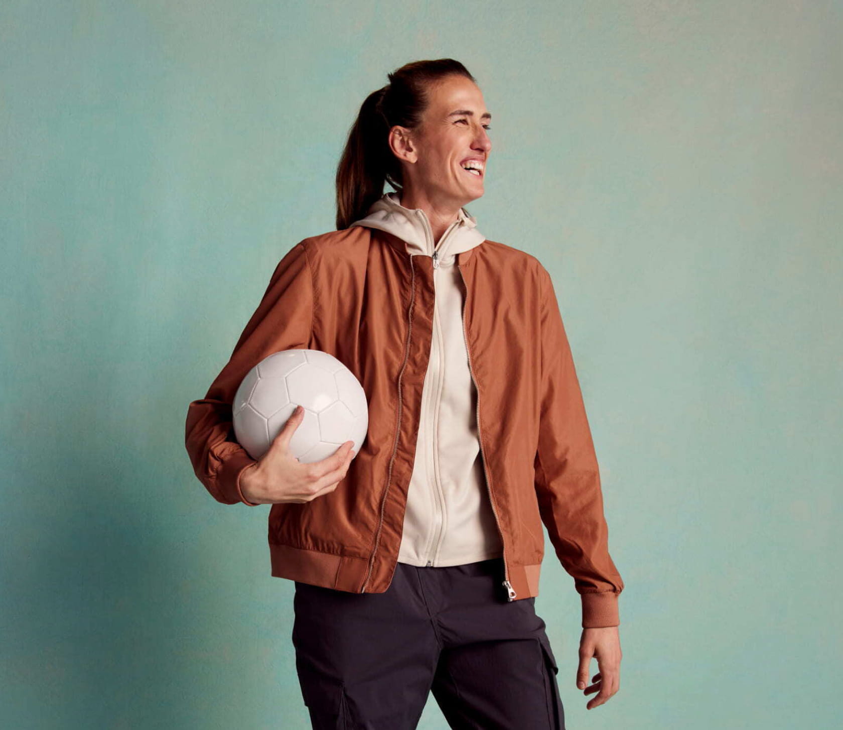 Woman footballer holding a ball