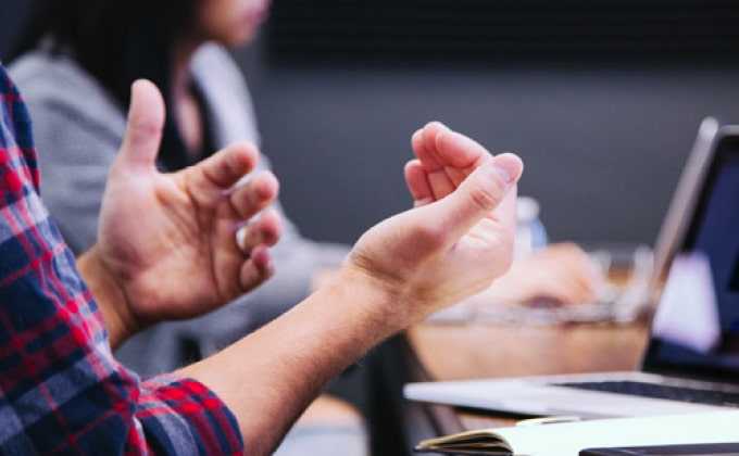 A pair of hands at a conference table